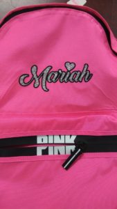 A pink bag with a glittered embroidery, “Mariah”