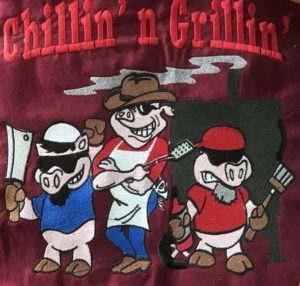 Three pigs and an embroidered text, “Chillin’ and Grillin’”